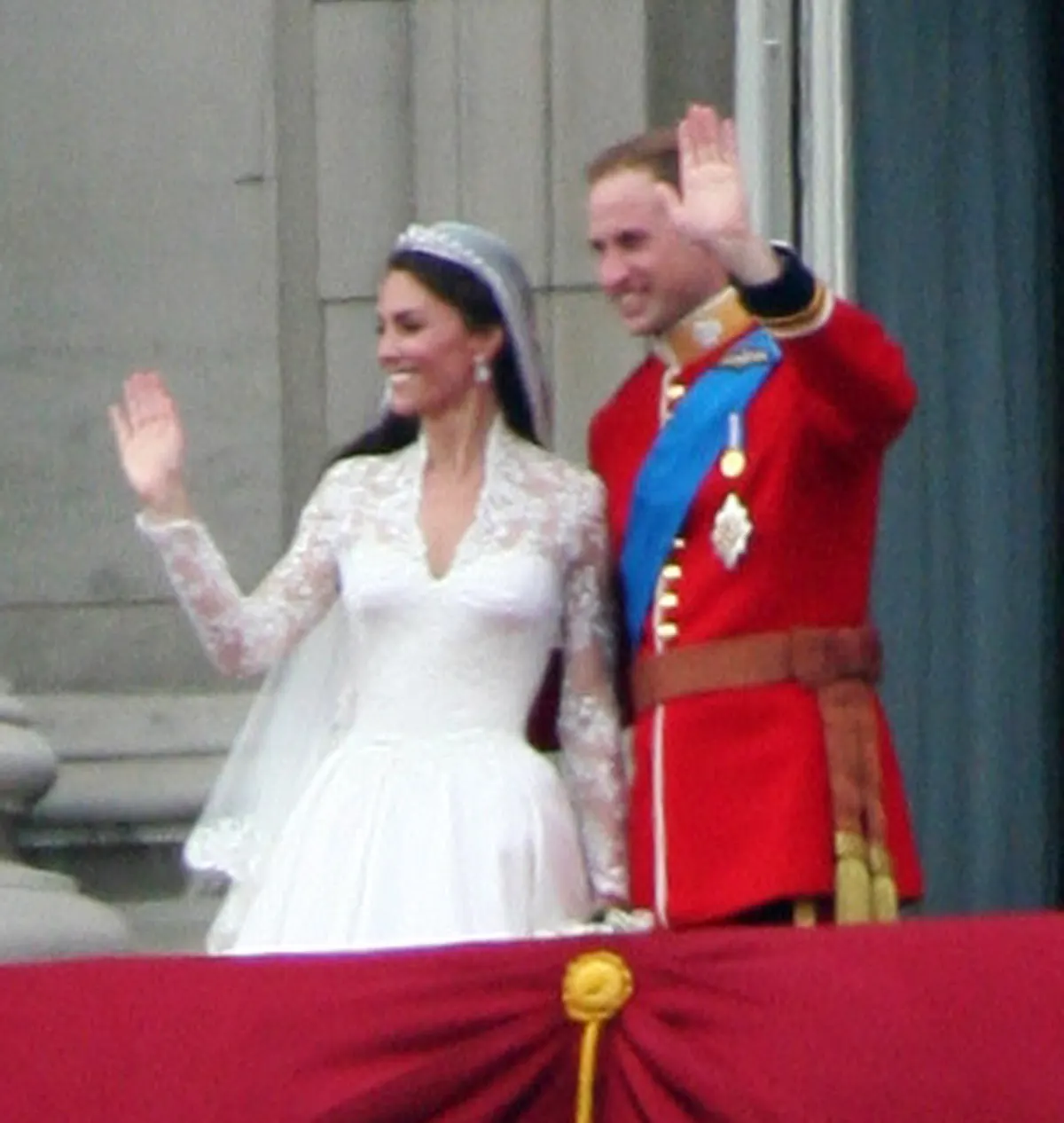 A photograph of Prince William of Wales and Catherine, the Duchess of Cambridge, waving from the balcony of Buckingham Palace after their wedding.