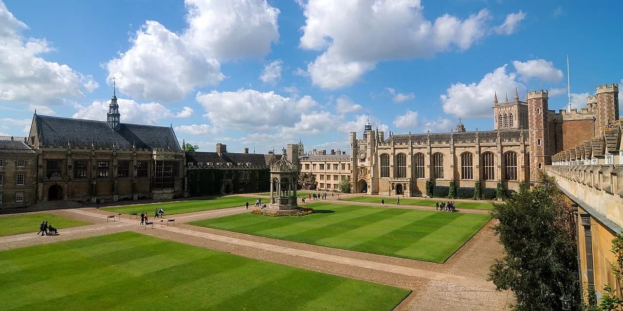 Cambridge University Trinity College Great Court with (from left to right) its dining hall, Master's Lodge, fountain, clock tower, chapel and Great Gate.