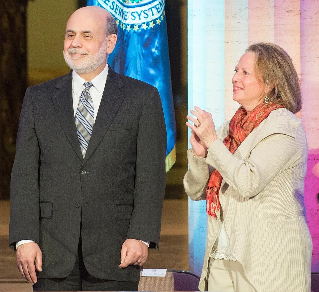 Chairman Ben S. Bernanke smiles alongside his wife, Anna, and Vice Chair Janet L. Yellen at a farewell reception held at the Marriner S. Eccles Federal Reserve 
