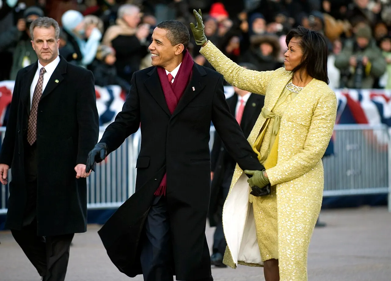 President Barack Obama and first lady Michelle Obama wave to the crowds lining Pennsylvania Avenue during the 56th Inaugural parade, Washington, D.C., Jan. 20, 