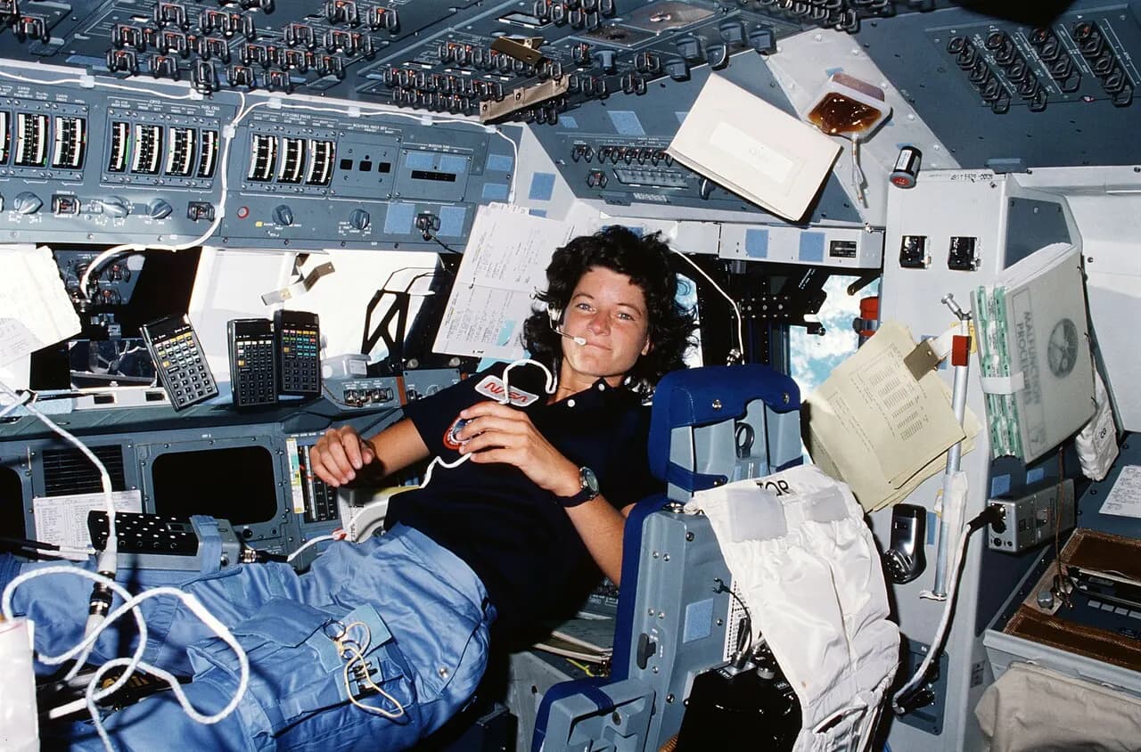 STS007-14-629 (21 June 1983) ---- Astronaut Sally K. Ride, STS-7 mission specialist, performs a number of functions simultaneously, proving the necessity for ve