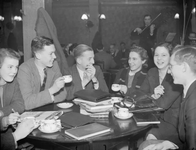 King's College London Students Evacuated To Bristol, England, 1940 James Macdonald Paterson (seen here holding a cup) enjoys a cup of tea or coffee with friends